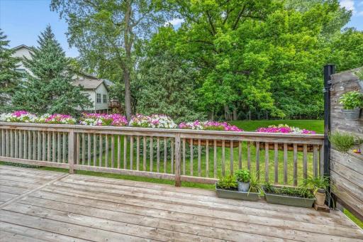 Another view of the deck and tranquil backyard beyond.