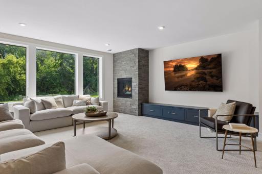 With a floor to ceiling stone gas fireplace