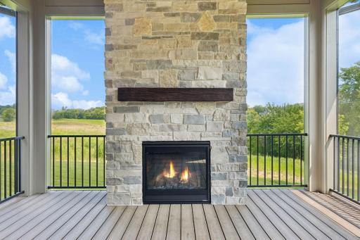 Stone fireplace. Porch leads to open deck and back yard