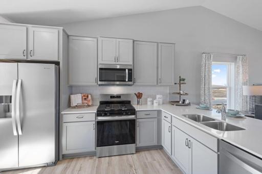 One of the first things you'll notice is our attention to detail throughout the layout, especially here in the kitchen! Photo is of actual home. Colors and options may vary. Ask Sales Agent for details.