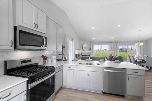 Large breakfast bar on the kitchen peninsula. Photo of actual Home. Options and colors may vary. Ask Sales Agent for details.