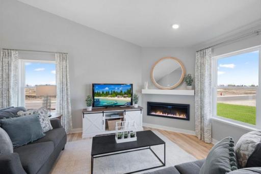 An electric burning fireplace completes the ambiance. Photo of Model Home. Options and colors may vary. Ask Sales Agent for details.