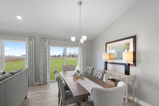 Dining room on the main level, this informal space is large enough to accommodate just about any dining room table configuration! Photo is of actual home. Colors and options may vary. Ask Sales Agent for details.