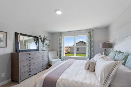 The primary bedroom is the perfect setting to start and finish each day! Furnished with a King size bed and furniture with plenty of space leftover. Photo is of actual home. Colors and options may vary. Ask Sales Agent for details.