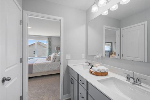 In addition to the space provided in the primary bedroom, the attached bath provides a true oasis to come home to, featuring a double vanity and stand-in shower. Photo of actual home. Colors and options may vary. Ask Sales Agent for details.