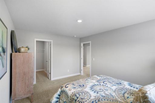 Another view of the lower level bedroom with walk-in closet. Photo is of similar home. Colors and options may vary. Ask Sales Agent for details.