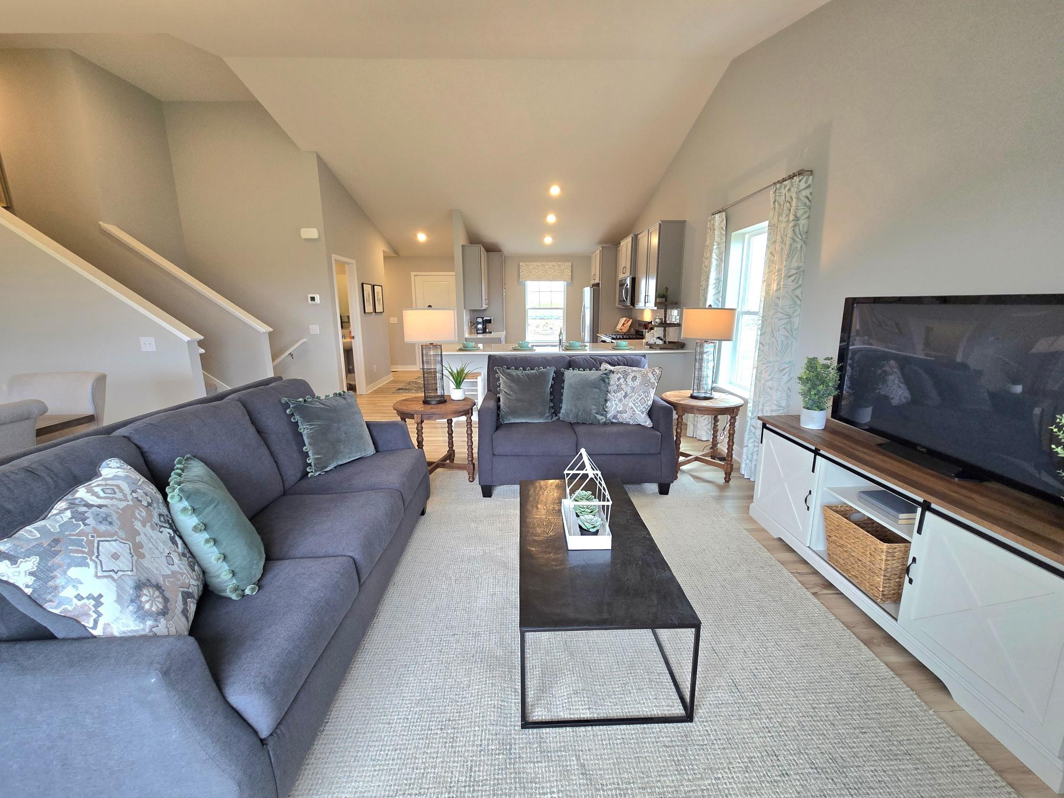 Cozy and comfortable living room, with ample space and natural light. Lots of space to relax. Photo of actual Home. Options and colors may vary. Ask Sales Agent for details.