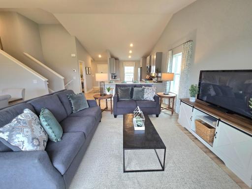 Cozy and comfortable living room, with ample space and natural light. Lots of space to relax. Photo of actual Home. Options and colors may vary. Ask Sales Agent for details.