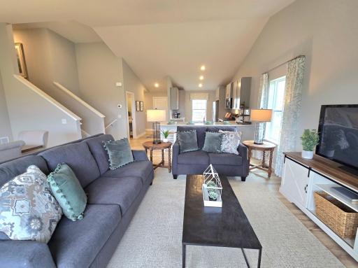 Extremely open and inviting, this main level is great for hosting or hanging out! Also, you can see the convenient main level bathroom nearby. Photo of actual Home. Options and colors may vary. Ask Sales Agent for details.