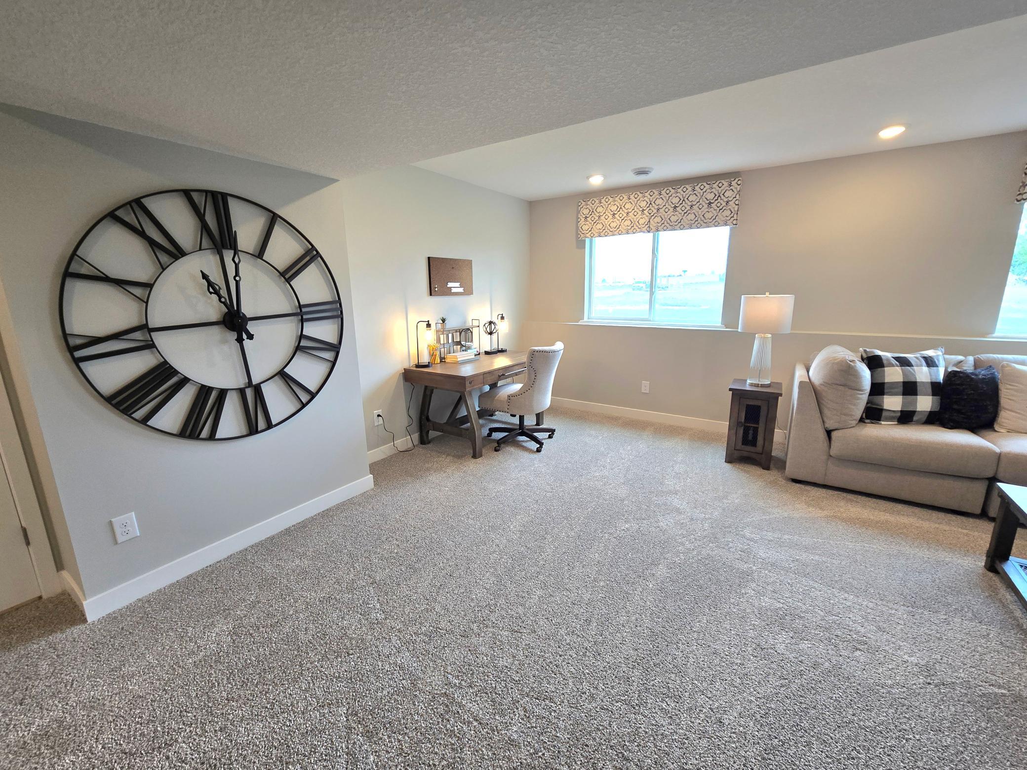 The Bryant II Lookout Lower Level Family Room at Highlands at Eagle View in Elko New Market. Photo is of actual home. Options and colors may vary. Ask Sales Agent for details.