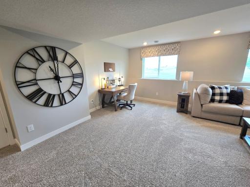 The Bryant II Lookout Lower Level Family Room at Highlands at Eagle View in Elko New Market. Photo is of actual home. Options and colors may vary. Ask Sales Agent for details.