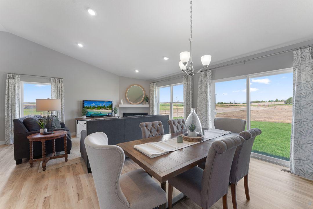 Open concept living with a modern electric fireplace. Our smart home package is included in every home. Photo is of actual home. Colors and options may vary. Ask Sales Agent for details.