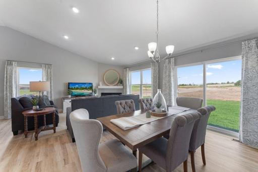 Open concept living with a modern electric fireplace. Our smart home package is included in every home. Photo is of actual home. Colors and options may vary. Ask Sales Agent for details.