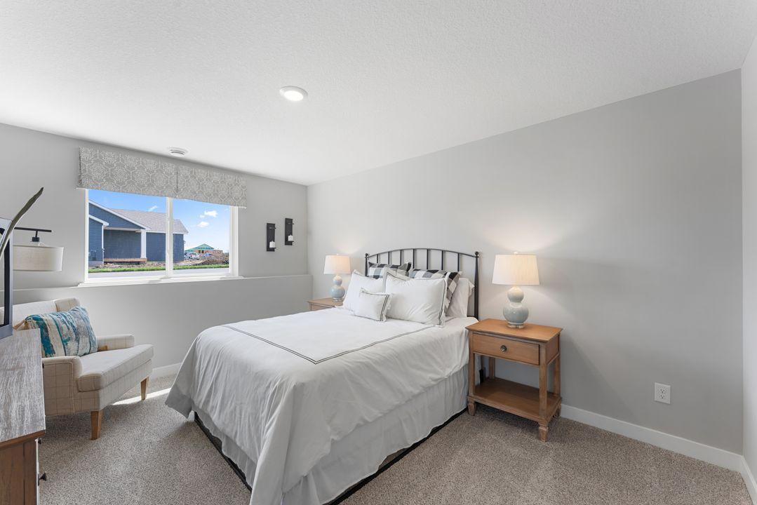 The lower level also includes this large bedroom, which has its own walk-in closet and immediate access to a full bathroom. Photo is of actual home. Colors and options may vary. Ask Sales Agent for details.