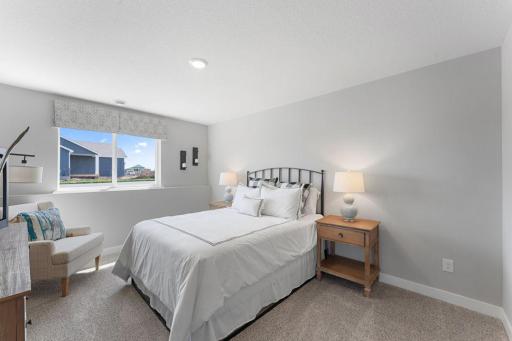 The lower level also includes this large bedroom, which has its own walk-in closet and immediate access to a full bathroom. Photo is of actual home. Colors and options may vary. Ask Sales Agent for details.