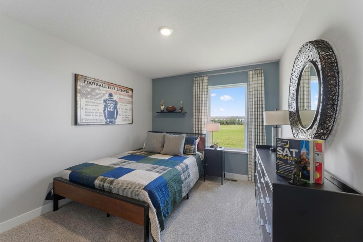In addition to the primary bedroom, the home's upper level also includes these two additional bedrooms, and another full bathroom just adjacent to each! Photo is of actual home. Colors and options may vary. Ask Sales Agent for details.