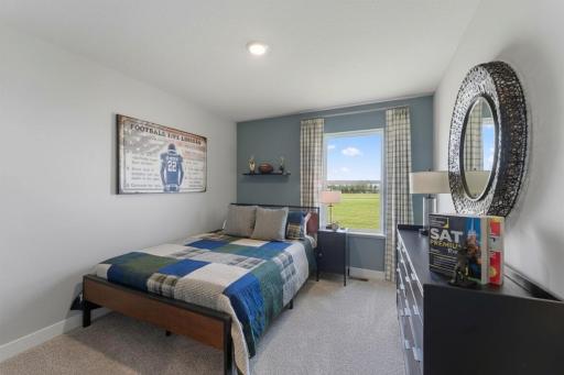 In addition to the primary bedroom, the home's upper level also includes these two additional bedrooms, and another full bathroom just adjacent to each! Photo is of actual home. Colors and options may vary. Ask Sales Agent for details.