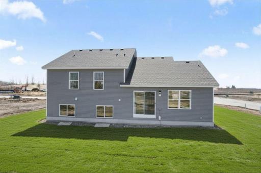 The Bryant II rear view of lookout lower level at Highlands at Eagle View in Elko New Market. Photo is of a actual home. Options and colors may vary. Ask Sales Agent for details. AI-generated landscaping for visualization. Actual yard condition may d