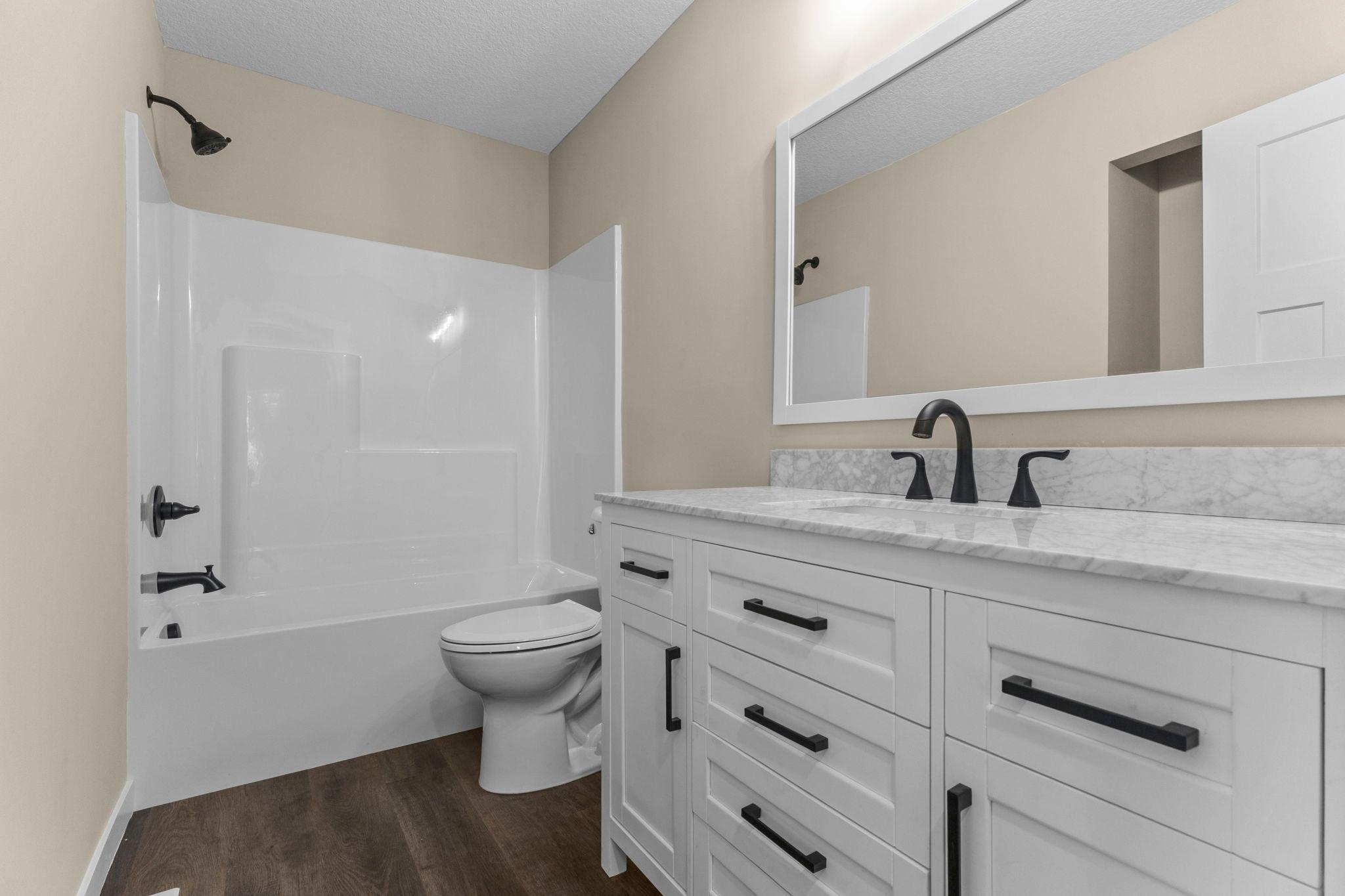 Upper-Level Full Bathroom: Beautifully updated with modern finishes, this full bathroom offers a clean, functional space with stylish details and thoughtful upgrades throughout.