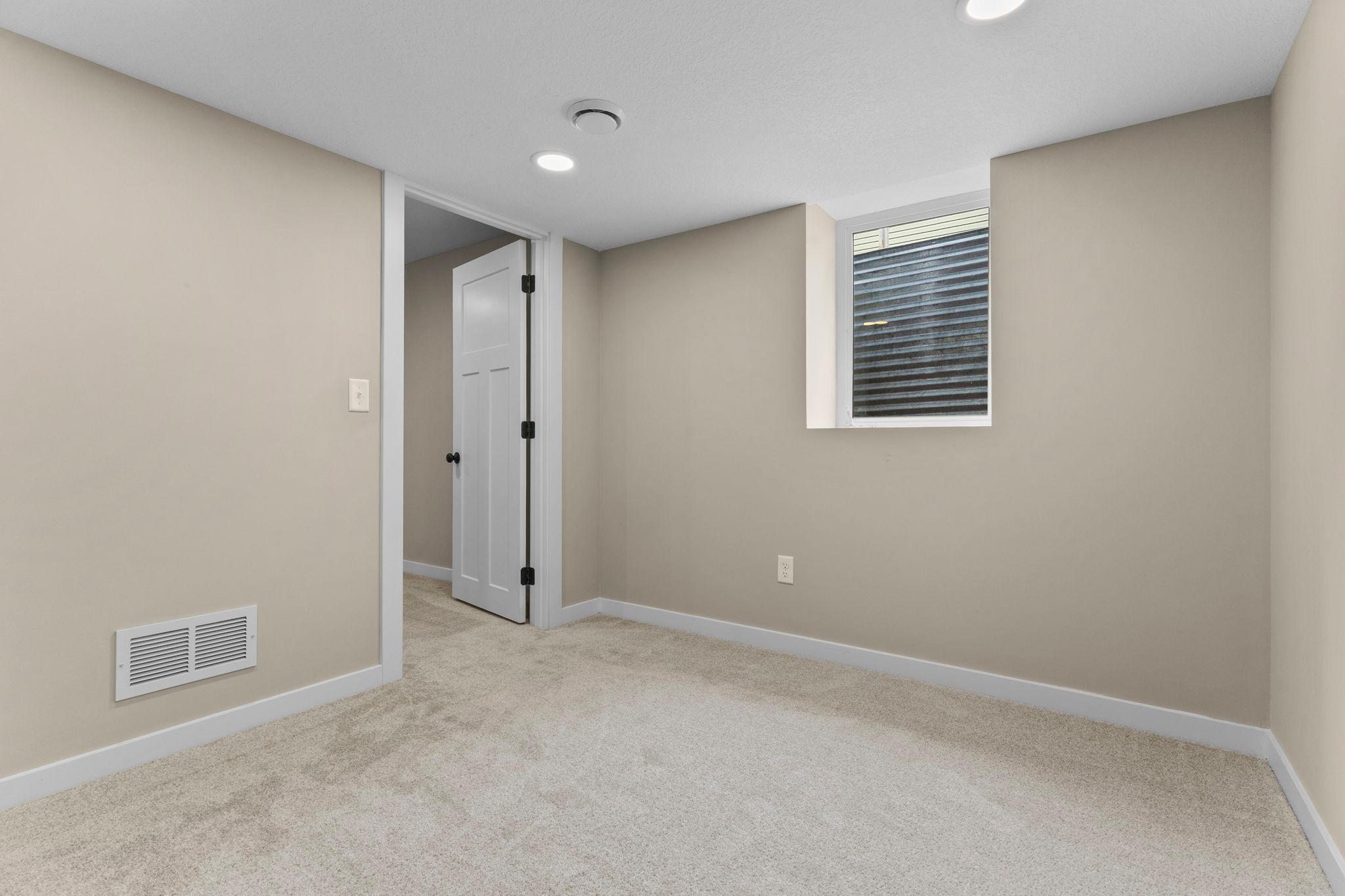 The finished fourth-level bonus room provides extra living space with an egress window, bringing in natural light and offering a convenient escape route from the lowest level.