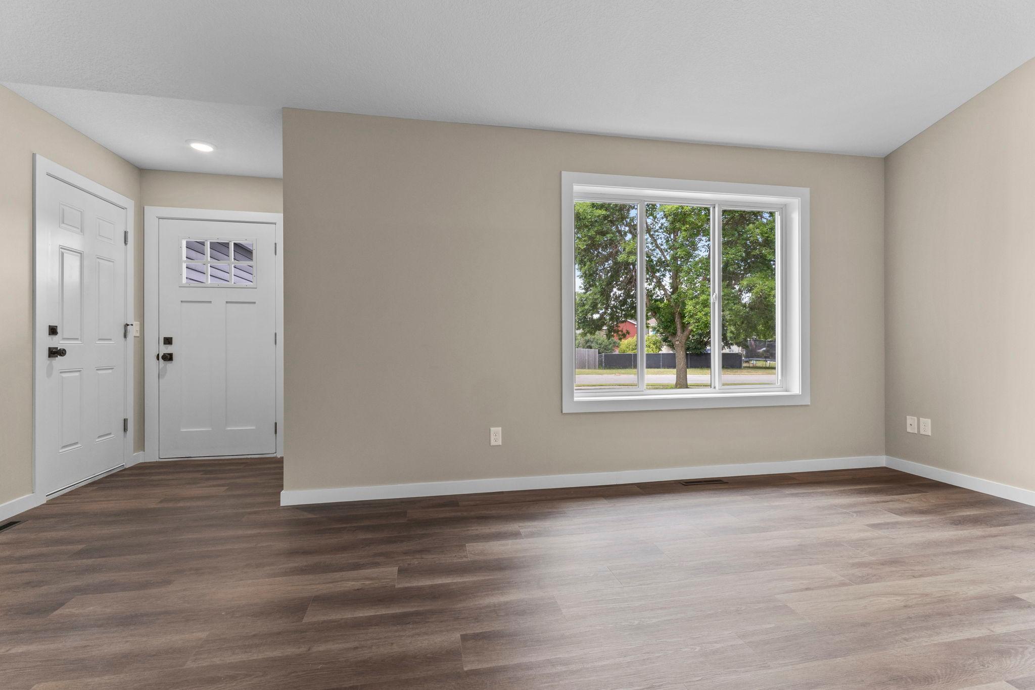 The main level features new luxury vinyl plank flooring throughout, newer windows, knockdown ceilings, updated six-panel doors, and new trim, giving the home a fresh, modern look.
