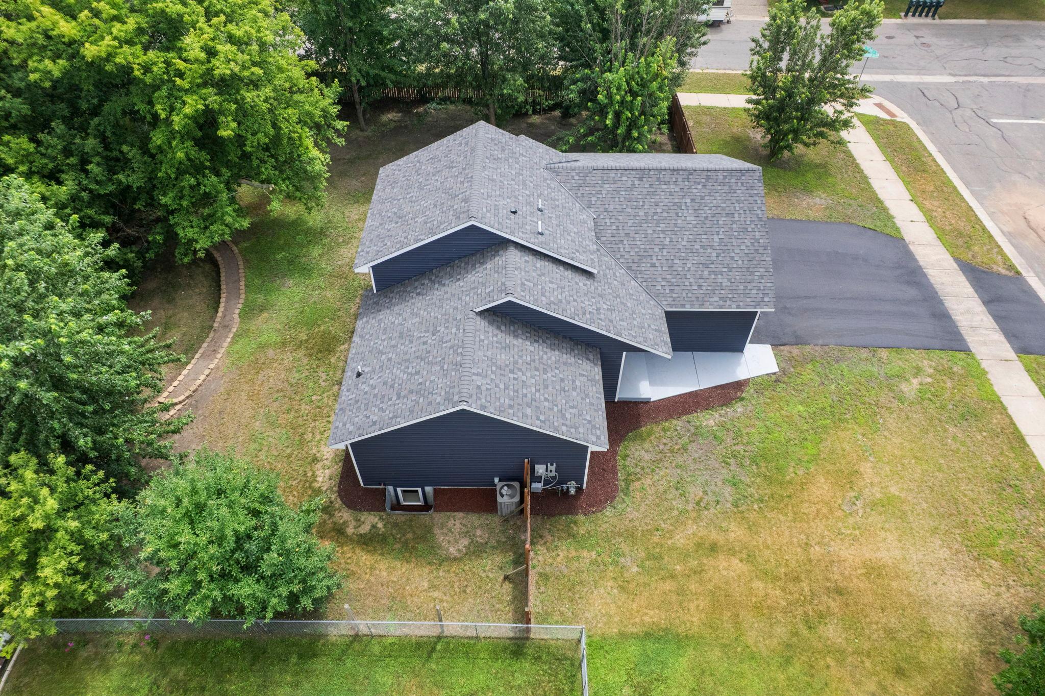 Enjoy the finishing touches of new landscaping and a newly installed asphalt driveway, creating a polished exterior with excellent curb appeal.
