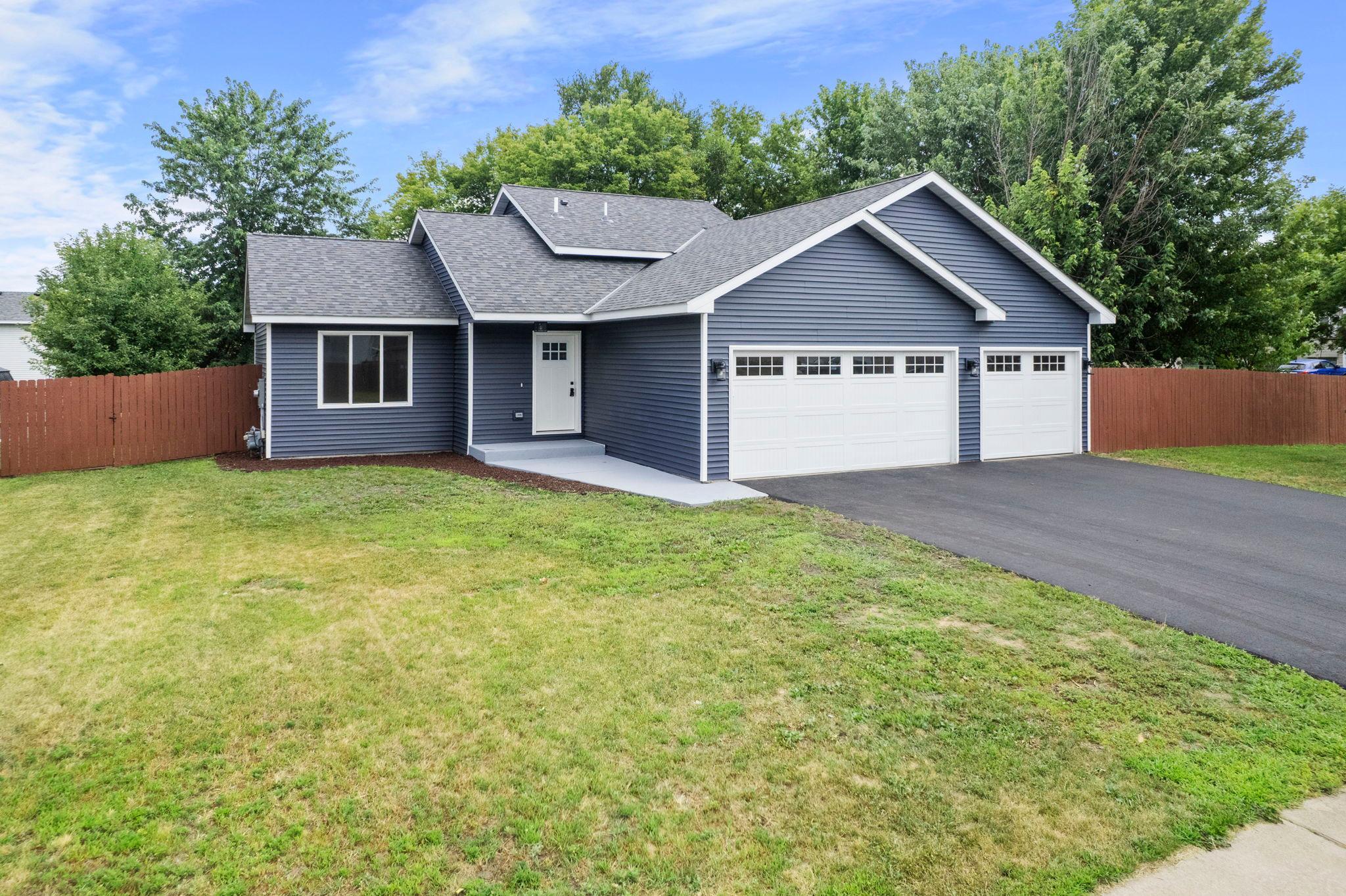 Major exterior improvements include new roof trusses, insulation, roofing materials, garage walls and doors, siding, soffits, a new front entry door, and a new asphalt driveway, providing lasting quality, enhanced curb appeal, and peace of mind.