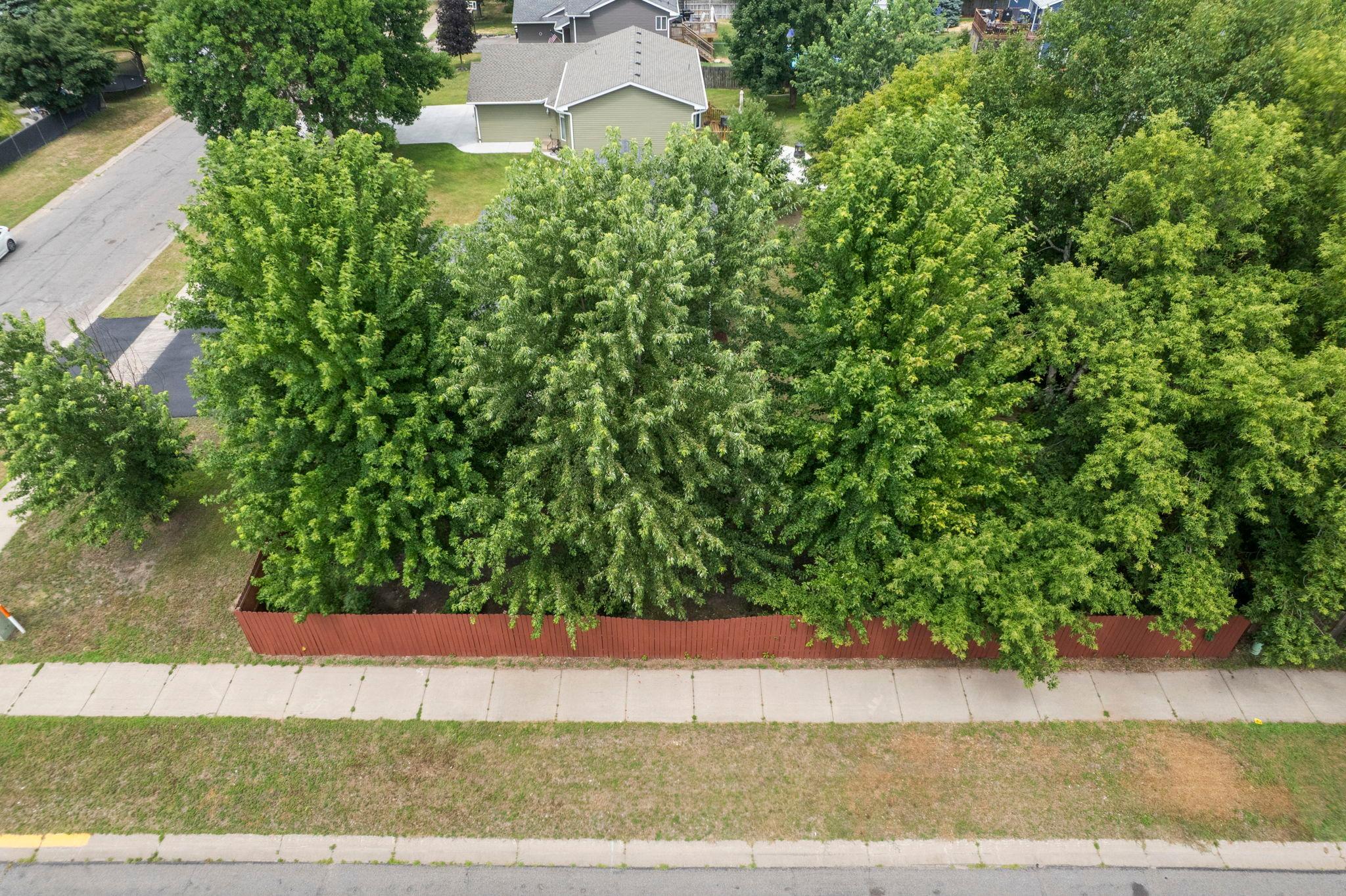 Enjoy the beauty of a corner lot with mature trees and a fenced backyard, providing a private retreat with plenty of space for outdoor living.
