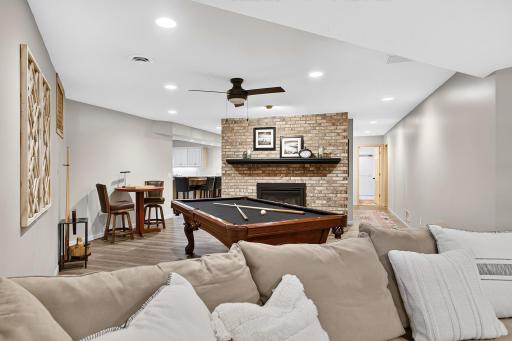 Gas fireplace and surround anchors the lower level and provides the perfect ambiance for get togethers.