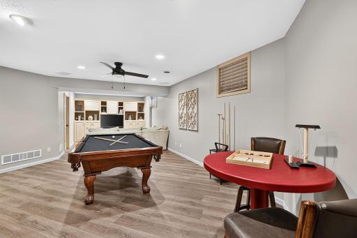 Lower level family room can accommodate billiard table and more seating.