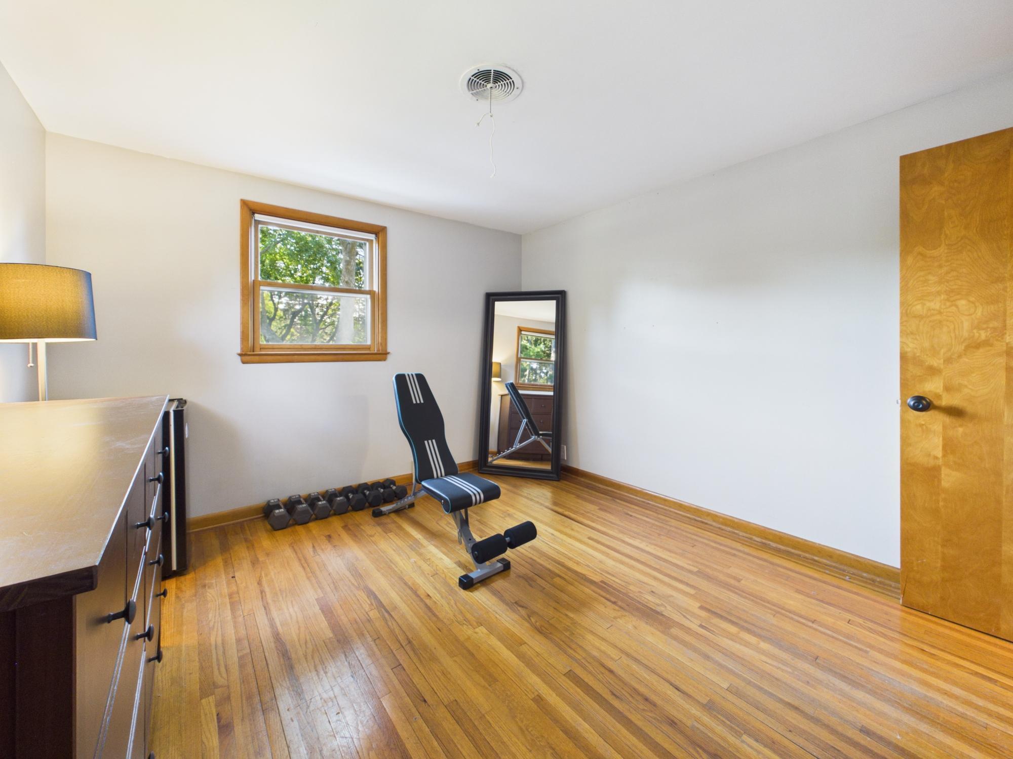 Bedroom 2 currently used as an exercise space, demonstrating the flexibility of the home's additional bedrooms.
