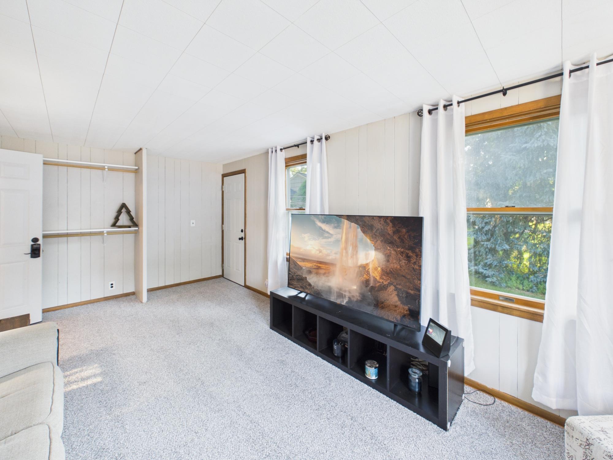 Another family room view highlighting the windows, natural light and generous dimensions of this versatile space.