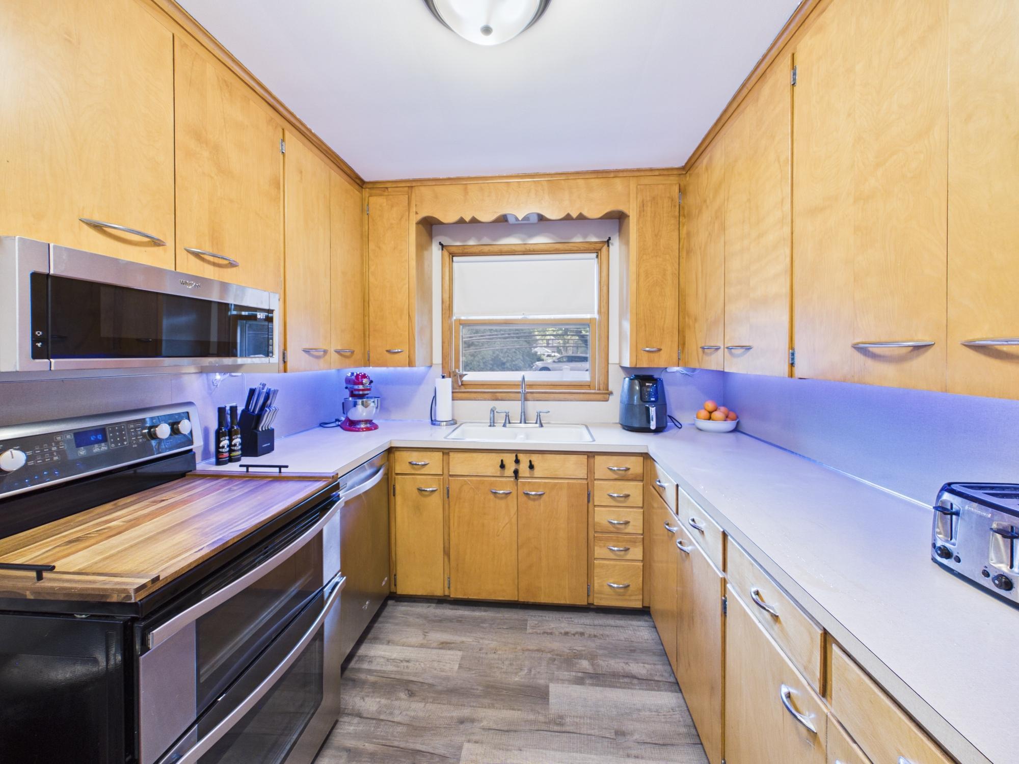 Another kitchen view highlighting the abundance of cabinet and counter space plus stainless steel appliances.