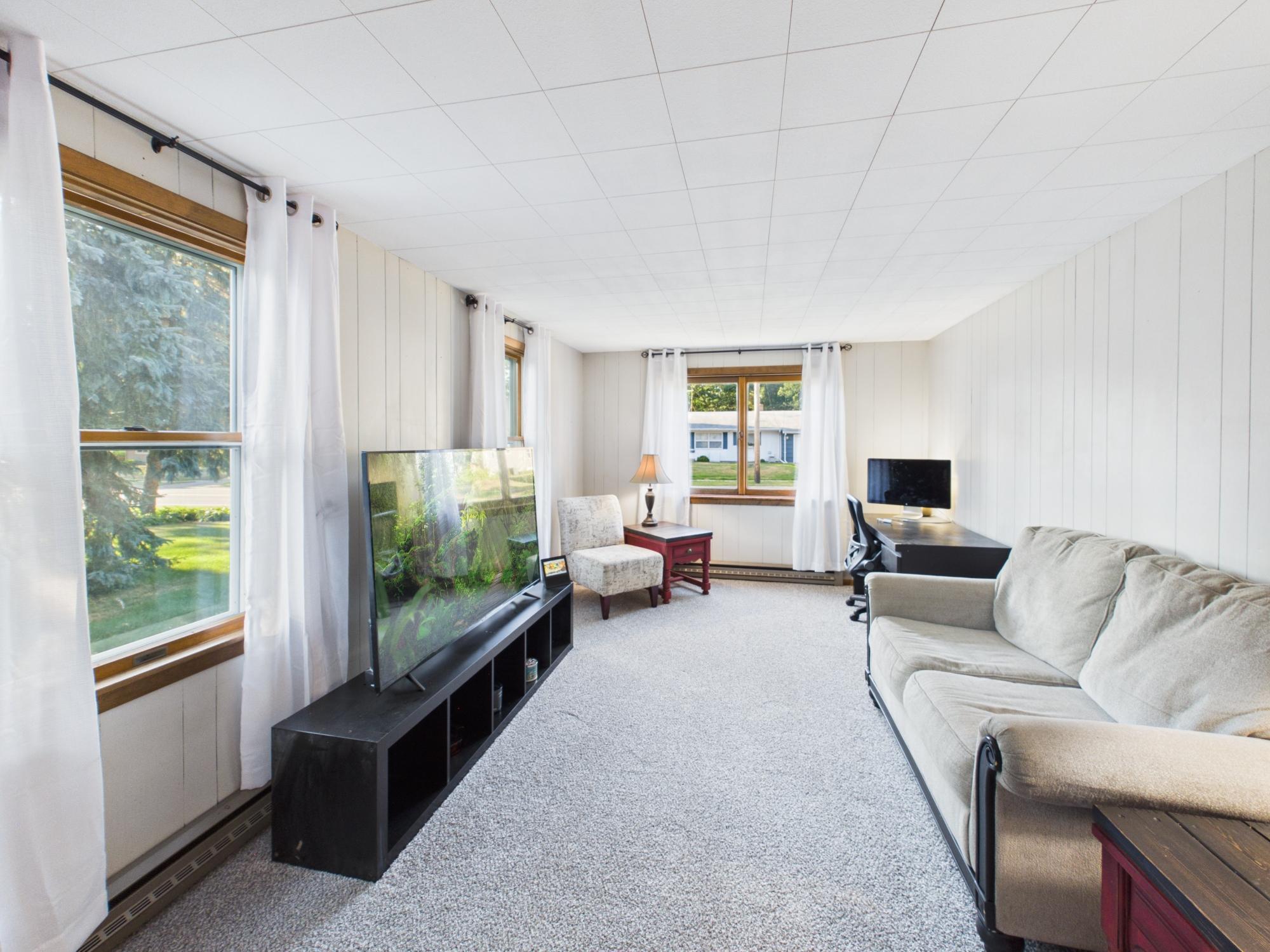 Family room shown from the opposite end, emphasizing the length of the room and the amount of additional living space.