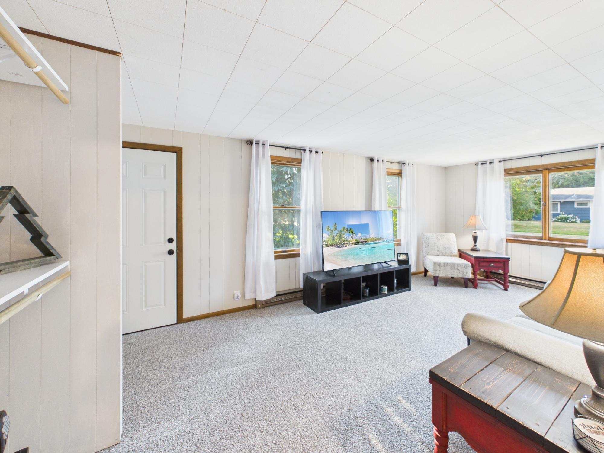 Spacious family room offering a second living area with windows on multiple sides and plenty of room to spread out.