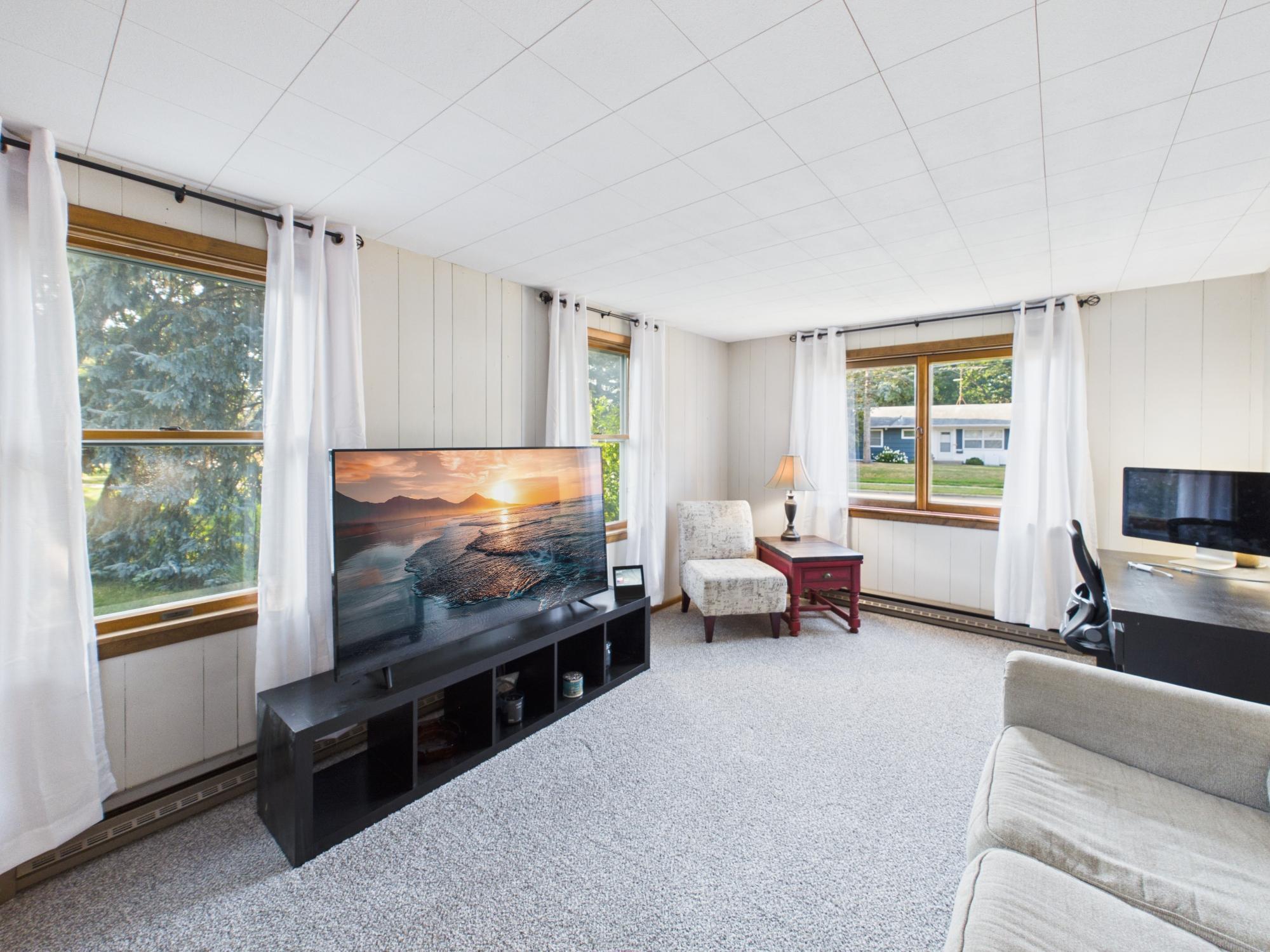 Family room with large windows overlooking the yard and flexible space for TV viewing, relaxing or entertaining.