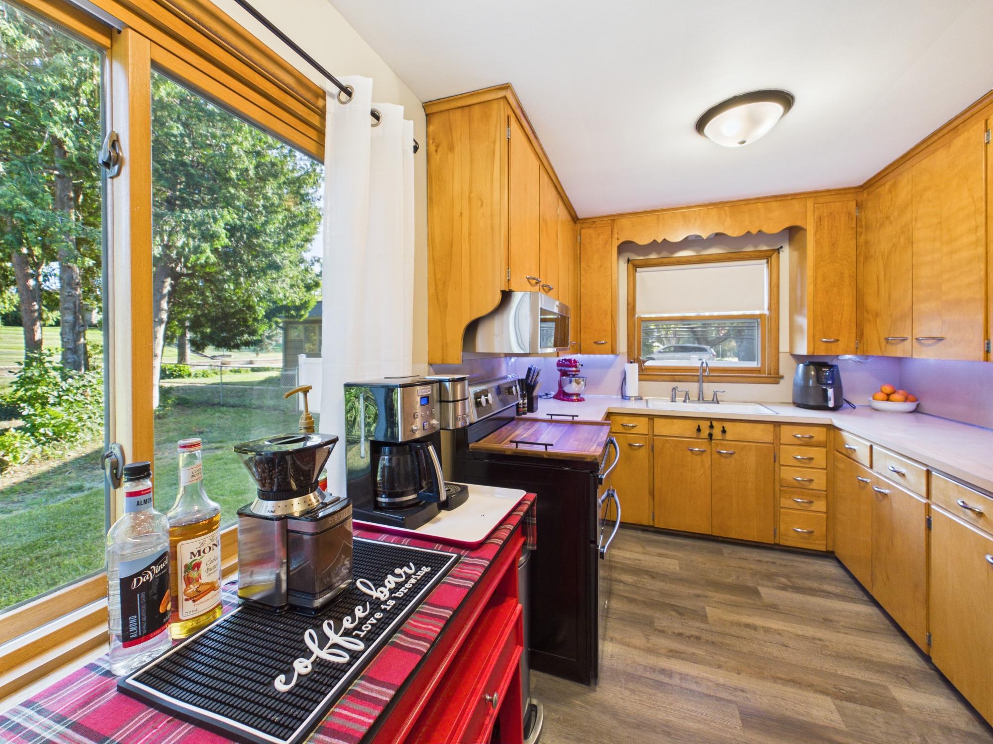 Kitchen window overlooking the backyard brings natural light into the workspace and keeps the beautiful yard in view.