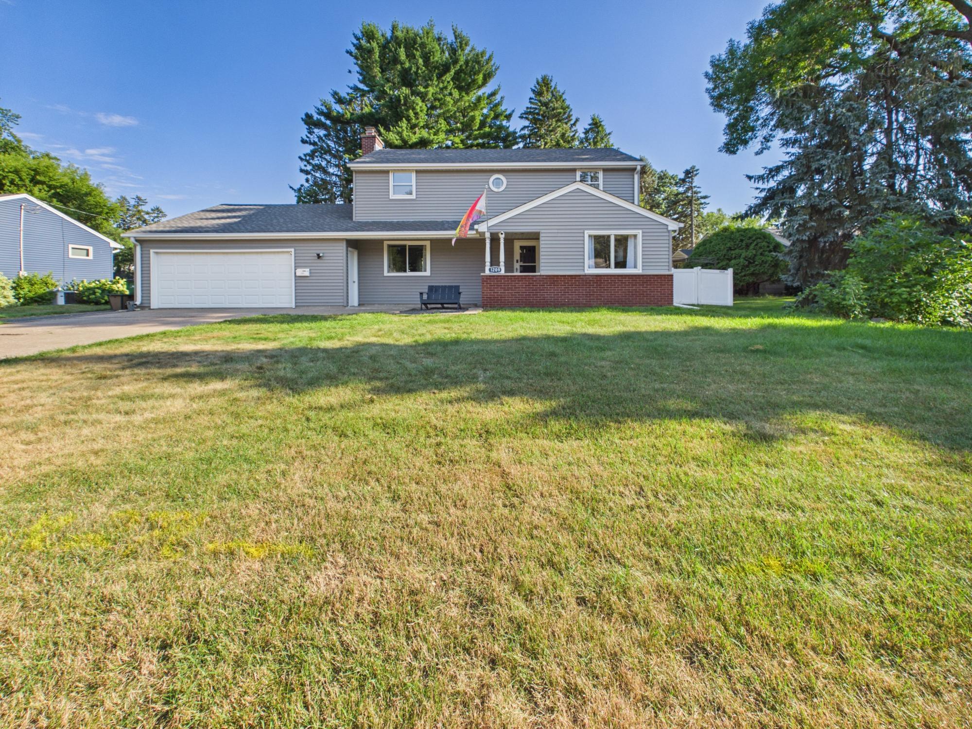 Front exterior of this Stillwater home featuring an attached two-car garage, newer roof and siding (2020) and a spacious front yard.