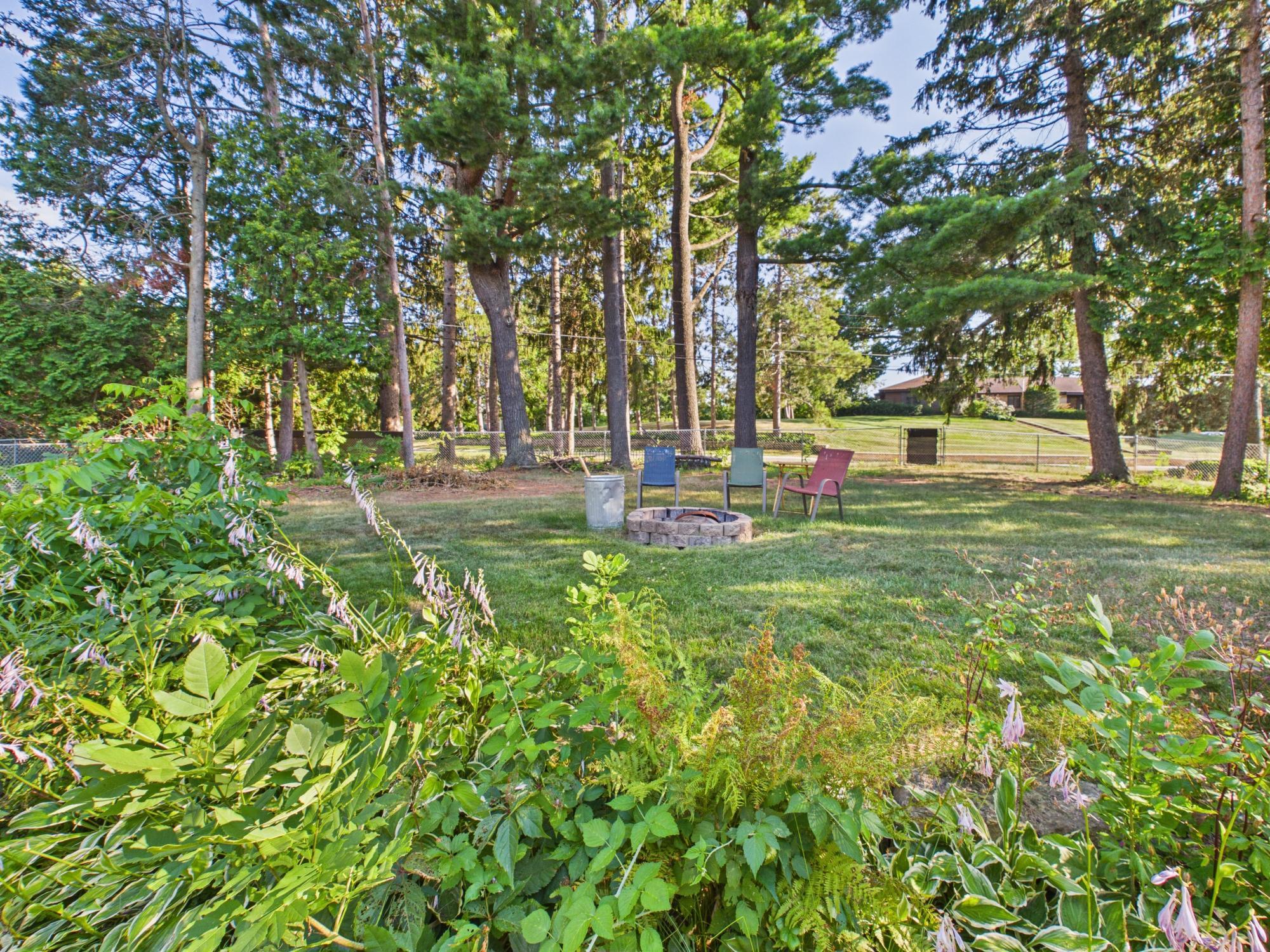Another view of the backyard highlighting the mature trees, established landscaping and generous amount of usable yard space.