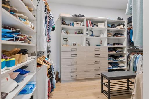 Primary walk-in closet with organizational components