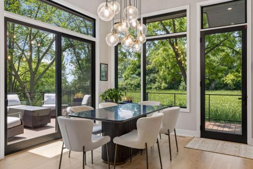 Walls of windows invite natural light and access to the deck