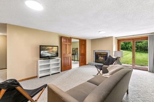 Lower level family room with gas fireplace and walk out patio