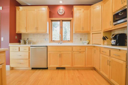The kitchen offers maple cabinetry, Bosch dishwasher, KitchenAid fridge & range