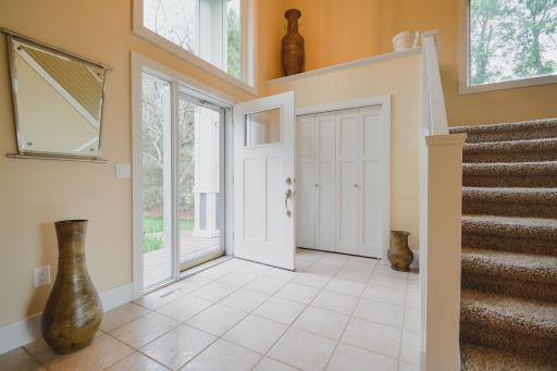 Spacious entry with soaring ceilings, tile flooring