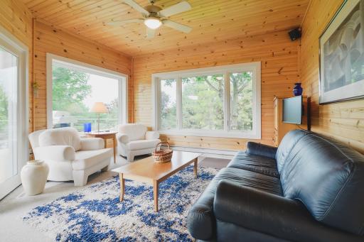 Additional seating and large glass doors lead to deck area