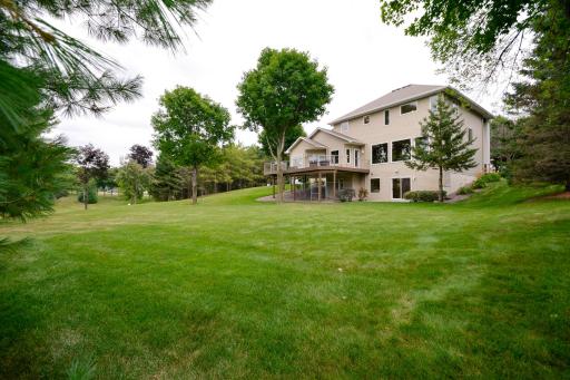 View of the back of the home with the maintenance-free deck & lower level walk out