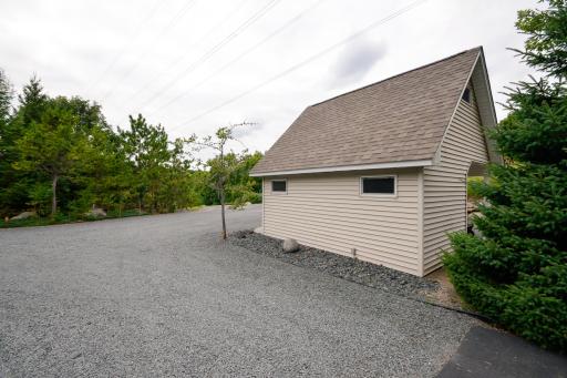 Additional storage shed next to driveway leading to outbuilding