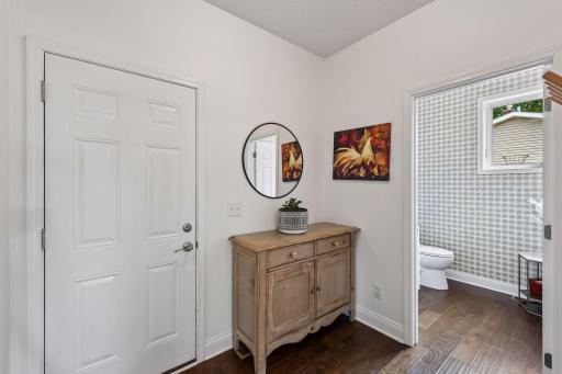 A convenient mudroom entry keeps daily life organized while the stylish main-level powder room offers guests a beautifully updated space with modern finishes and designer wallpaper.