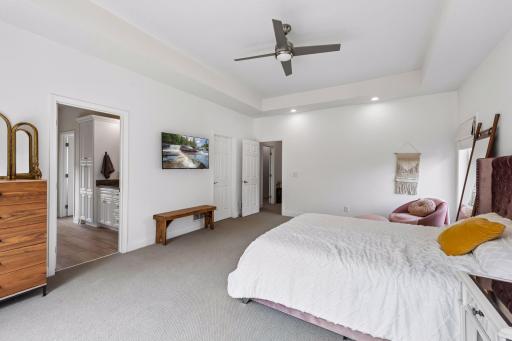 Wake up to beautiful treetop views from this expansive primary suite. The generous layout easily accommodates large furnishings while offering comfort, privacy, and abundant natural light.