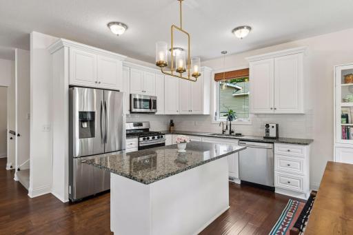 Enjoy abundant cabinetry, expansive granite counters, stainless appliances, and a functional layout that makes cooking and entertaining equally enjoyable. Everything is within easy reach.